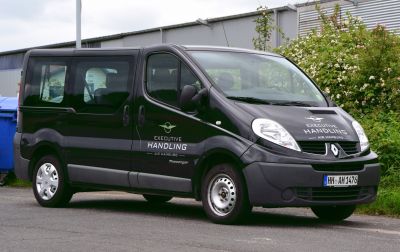 Black passenger van with sliding side door and large windows