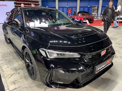 Close-up of aggressive front design with hood vent and LED headlights