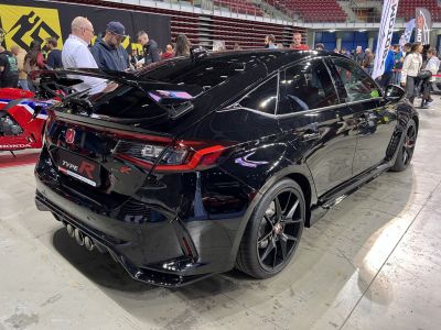 Rear view of a sporty hatchback with spoiler and quad exhaust