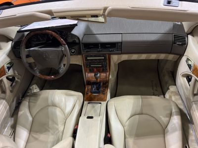 Wood trim dashboard and beige leather seats with classic automatic gear shift