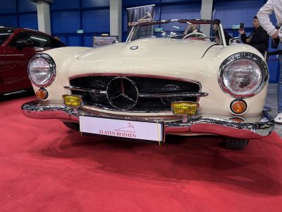 Front view with round headlights, chrome bumper, and classic grille