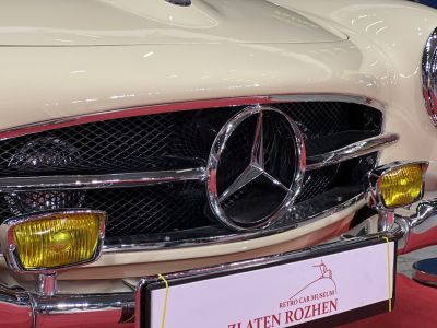 Vintage car front grille with star emblem and yellow fog lights