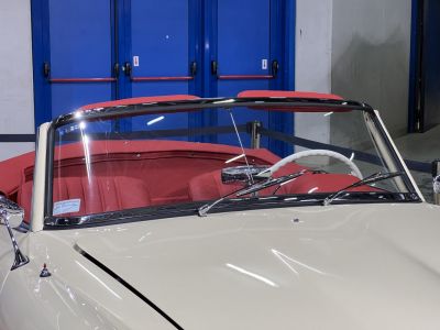 Convertible windshield, red leather seats, chrome trim