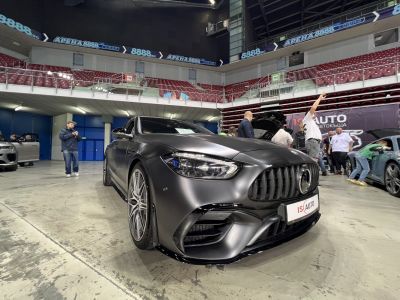 Matte black sports sedan front with aggressive grille and sharp headlights