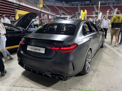 Matte black luxury sedan rear with LED tail lights and quad exhausts