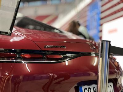 Close-up of AMG GT tail light and AMG badge on rear in glossy finish