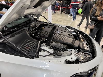 Open hood view showing detailed Mercedes-Benz coupe engine bay.