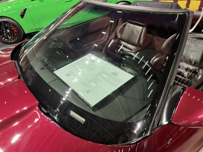 Convertible windshield with leather seats and steering wheel visible