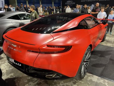 Sporty rear view of red matte finish luxury coupe with sleek taillights and alloy wheels