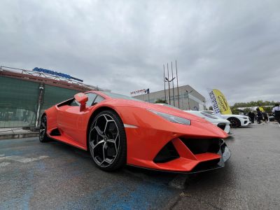 Front and side perspective of a sporty coupe with aggressive design and unique wheels.