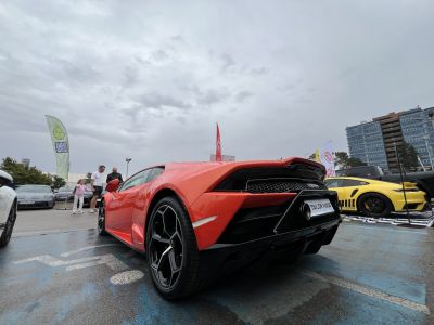 Rear view of a red sports car with angular diffuser and hexagonal exhausts.