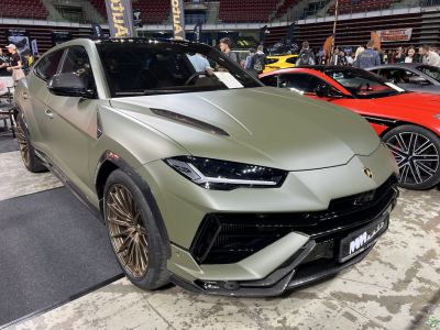Matte green front view with bronze wheels and carbon fiber accents