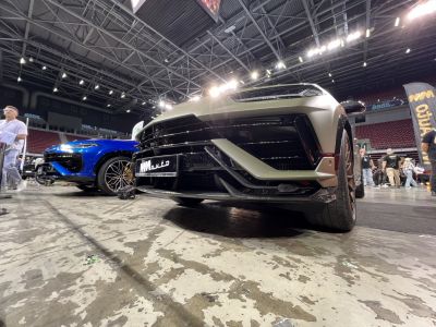 Close-up of front grille and sporty wheel design with aggressive bumper lines