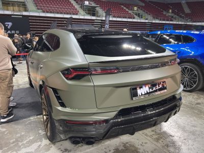 Matte green SUV rear with carbon fiber diffuser and quad exhaust