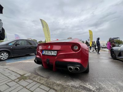 Rear view of red sports car with dual exhaust and round taillights