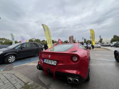 Red sports car rear with quad exhausts and round taillights