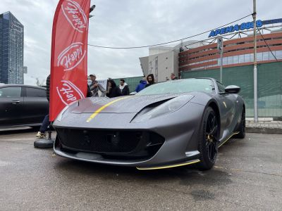 Matte gray supercar front with yellow racing stripes and black wheels