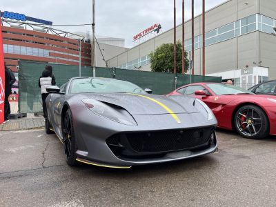 Front view of high-performance sports car with yellow racing stripe.