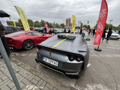 Rainy rear view of Ferrari 812 Superfast with yellow stripe and round tail lights