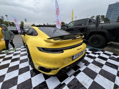 Yellow sporty coupe with active rear spoiler and LED taillights
