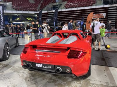 Rear with dual exhausts and engine bay vents of a red sports car