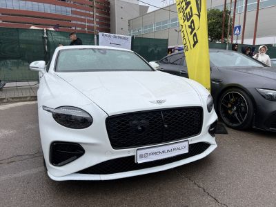 White luxury vehicle with black mesh grille and sleek LED headlights