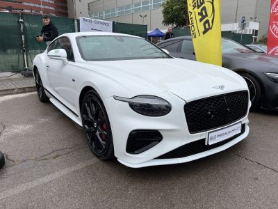 White luxury coupe with black alloy wheels and modern headlights