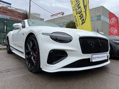 Close-up of front grille and oval headlight design on luxury sports coupe