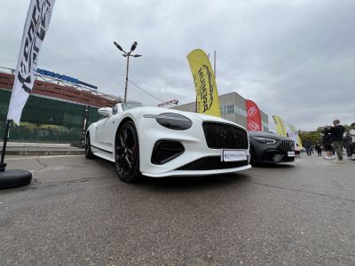 Close-up of luxury front grille and headlights with black wheels