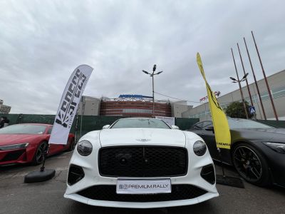 Front view of a luxury coupe with aggressive grille and sleek headlights