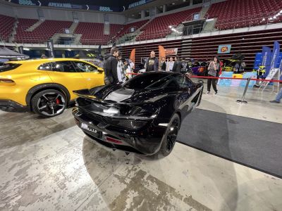 Black supercar rear view with aerodynamic design and distinctive lights