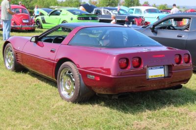 Rear view of a 1990s sports coupe with quad circular tail lights and fastback glass