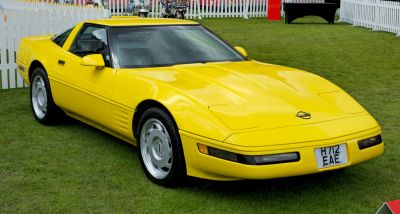 Yellow sports coupe with aerodynamic body and pop-up headlights