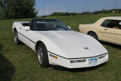 White convertible with pop-up headlights and streamlined body.