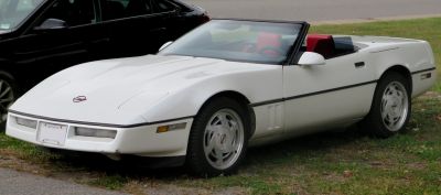 White convertible with pop-up headlights and red interior