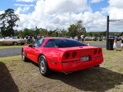 Red sports coupe rear with four round taillights