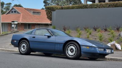 Blue classic sports coupe with sleek side profile and distinctive wheels