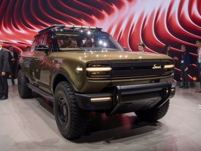 Front view of rugged electric truck with LED lights and off-road tires