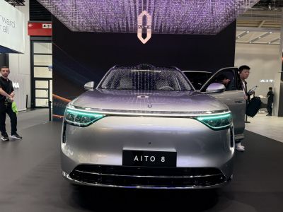 Front view of electric SUV with LED headlamps and aerodynamic design.