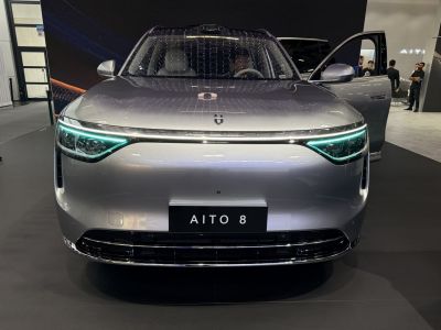 Sleek front with LED headlights and open front door.