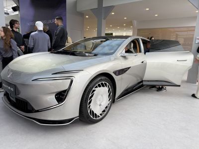 Futuristic front design with unique headlights and open driver door
