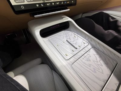 Center console with wood grain finish and integrated controls