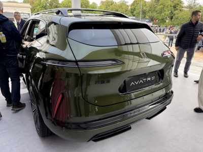 Glossy rear with sleek horizontal taillights and roof spoiler