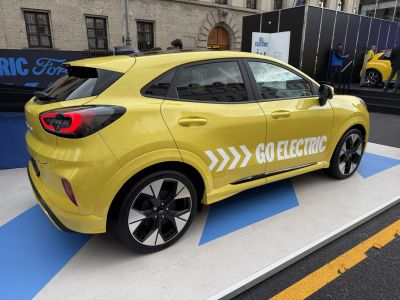 Electric hatchback with distinct LED rear lights and 'GO ELECTRIC' decal.