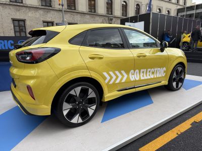 Electric vehicle side view with Go Electric branding and alloy wheels