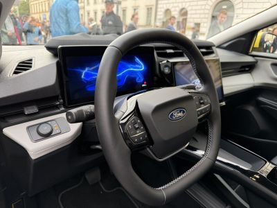 Multifunction steering wheel and digital instrument cluster in car interior