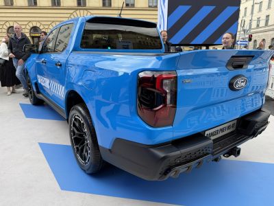 Blue pickup rear and side view with sporty taillights and electric hybrid badging