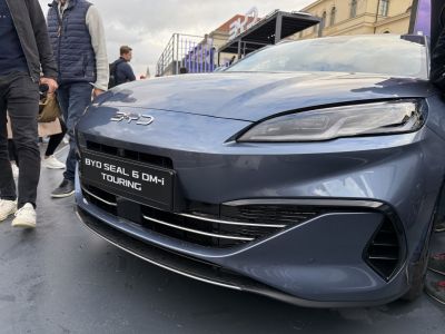 Close-up of sporty front end with sleek headlights and grille.