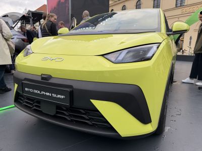 Close-up of car front with sleek headlights and distinct grille