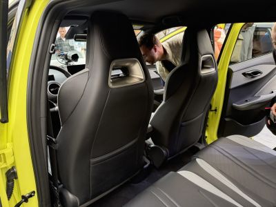 Rear view of advanced leather seats and door panels inside a compact car.